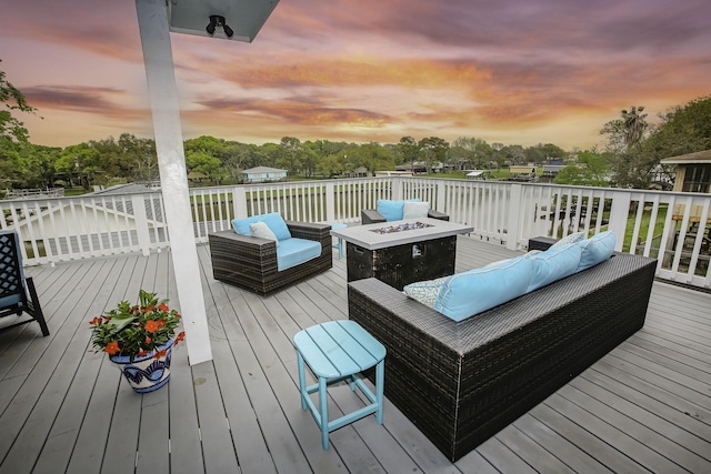 deck with an outdoor living space with a fire pit
