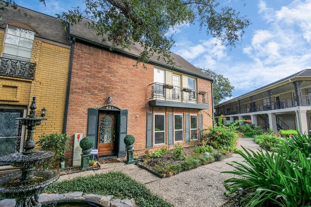 11525 Burdine St Unit 421, Houston, TX 77035 - exterior space with brick siding, a shingled roof, and a balcony