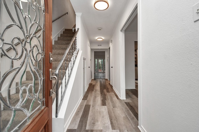 11525 Burdine St Unit 421, Houston, TX 77035 - hall featuring stairs, wood finished floors, baseboards, and a textured wall