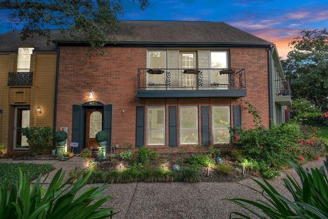 11525 Burdine St Unit 421, Houston, TX 77035 - view of front facade featuring a balcony, brick siding, and roof with shingles
