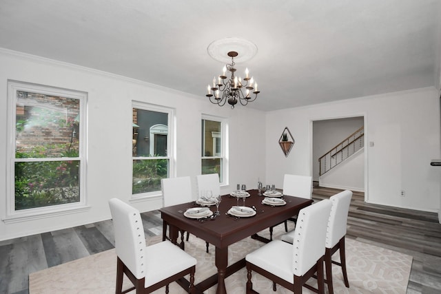 11525 Burdine St Unit 421, Houston, TX 77035 - dining room featuring stairway, an inviting chandelier, wood finished floors, and ornamental molding