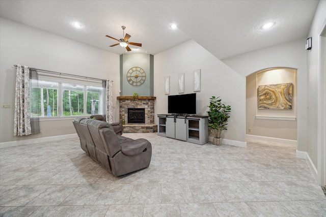 4106 Tee Tree Ct, Spring, TX 77386 - living area featuring a ceiling fan, a stone fireplace, baseboards, recessed lighting, and arched walkways