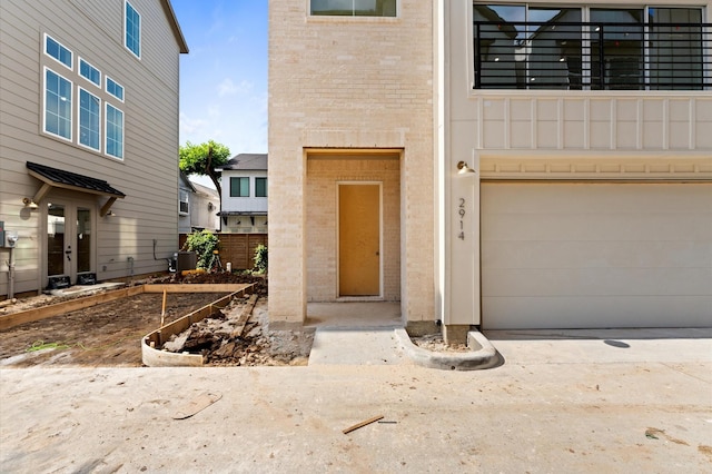 2932 Michaux St, Houston, TX 77009 - entrance to property featuring brick siding, concrete driveway, cooling unit, and a garage