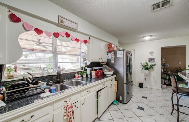 1421 Glenmore Forest St, Houston, TX 77055 - kitchen featuring visible vents, white cabinets, stainless steel refrigerator with ice dispenser, and a sink
