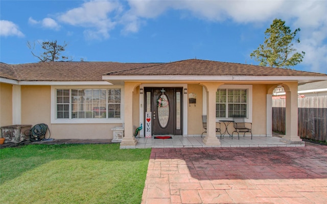 1421 Glenmore Forest St, Houston, TX 77055 - doorway to property with stucco siding, a lawn, a shingled roof, and fence