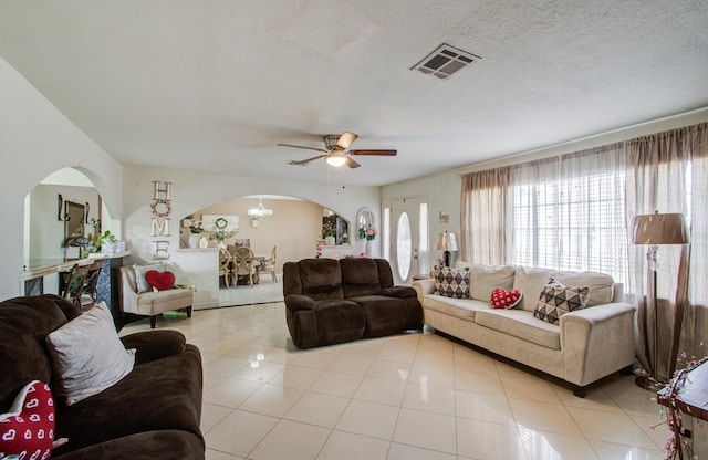 1421 Glenmore Forest St, Houston, TX 77055 - living area featuring visible vents, light tile patterned floors, ceiling fan with notable chandelier, arched walkways, and a textured ceiling