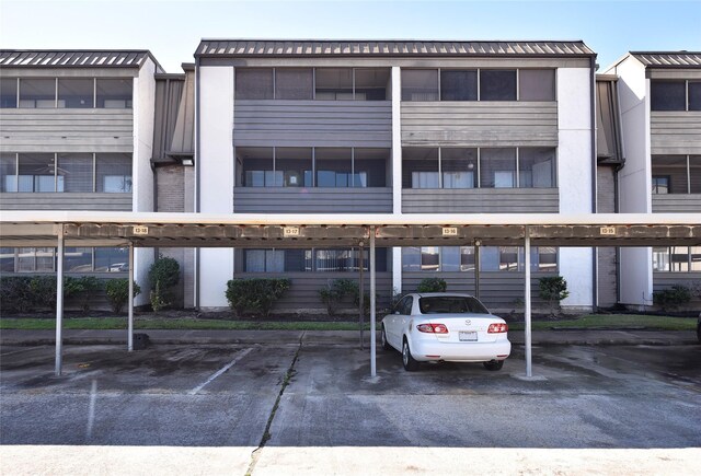 view of building exterior with covered parking
