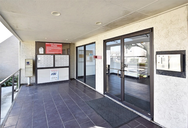 view of exterior entry with stucco siding