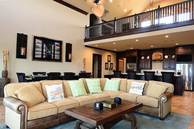 living area with a high ceiling and recessed lighting