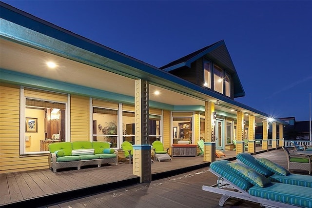 deck at twilight featuring outdoor lounge area