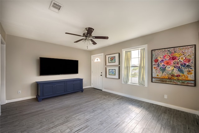 1719 Lombardy St, Houston, TX 77023 - unfurnished living room featuring ceiling fan, wood finished floors, and baseboards