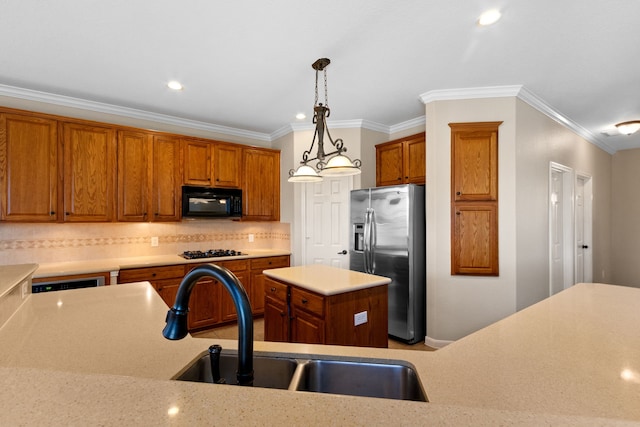 kitchen with a sink, light countertops, black appliances, and brown cabinetry