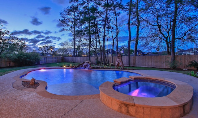 view of pool with a fenced backyard and a pool with connected hot tub