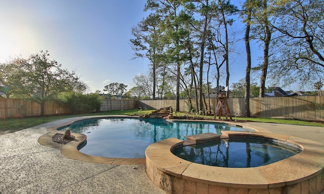 view of swimming pool with a fenced backyard, a pool with connected hot tub, and a patio