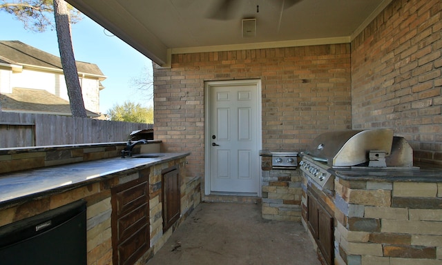 view of patio featuring an outdoor kitchen, a sink, area for grilling, and fence