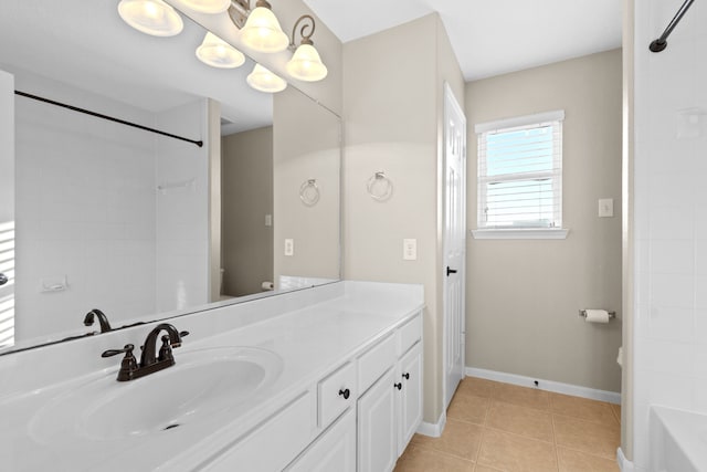 bathroom featuring walk in shower, baseboards, vanity, a tub to relax in, and tile patterned flooring