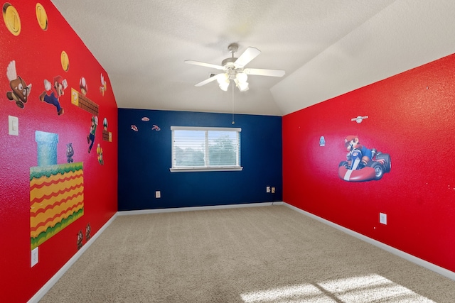 unfurnished bedroom featuring lofted ceiling, baseboards, a textured ceiling, carpet floors, and ceiling fan