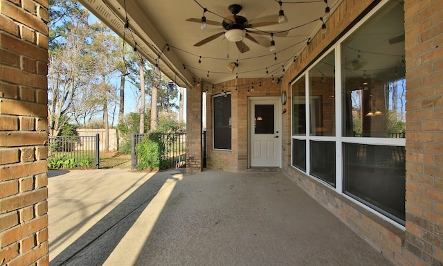 view of patio with fence and ceiling fan