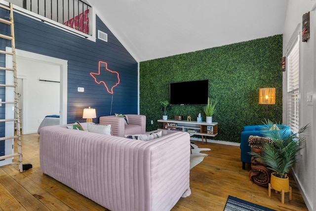 1072 Johnson Rd, Gilchrist, TX 77617 - living area featuring hardwood / wood-style floors, vaulted ceiling, and an accent wall