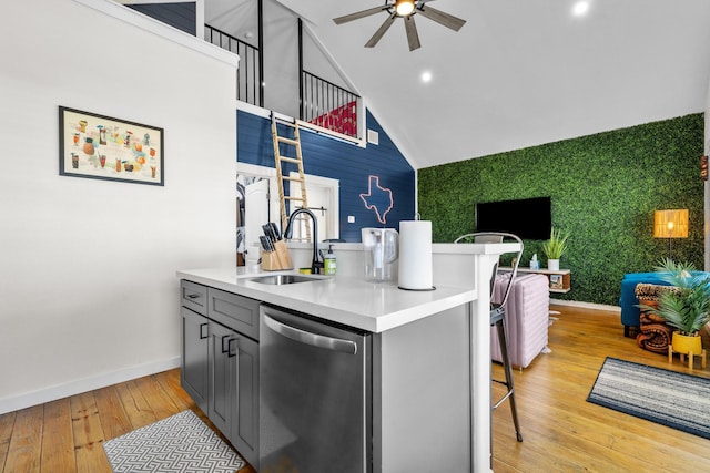 1072 Johnson Rd, Gilchrist, TX 77617 - kitchen with dishwasher, a sink, ceiling fan, baseboards, and an accent wall