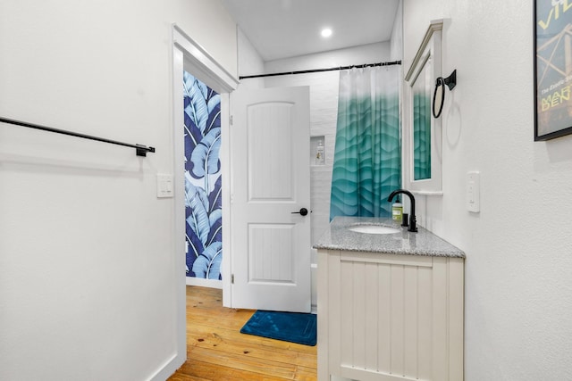 1072 Johnson Rd, Gilchrist, TX 77617 - full bathroom featuring wood-type flooring, vanity, curtained shower, and recessed lighting