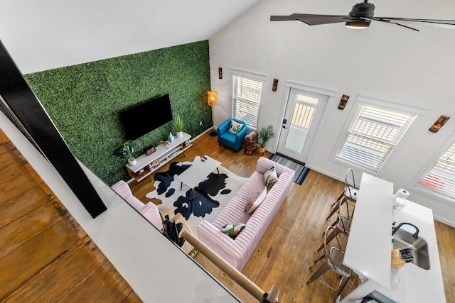 1072 Johnson Rd, Gilchrist, TX 77617 - living area featuring high vaulted ceiling, wood finished floors, a ceiling fan, and baseboards