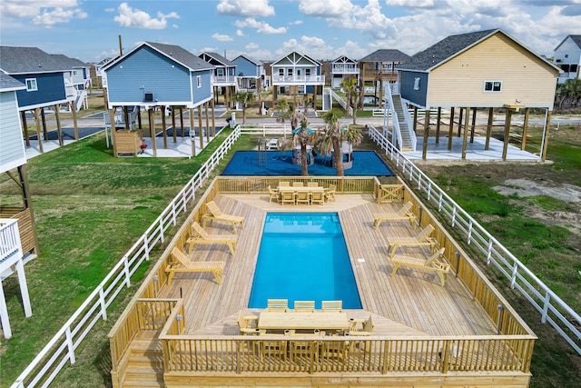 1072 Johnson Rd, Gilchrist, TX 77617 - community pool with a residential view, outdoor dining area, and a lawn