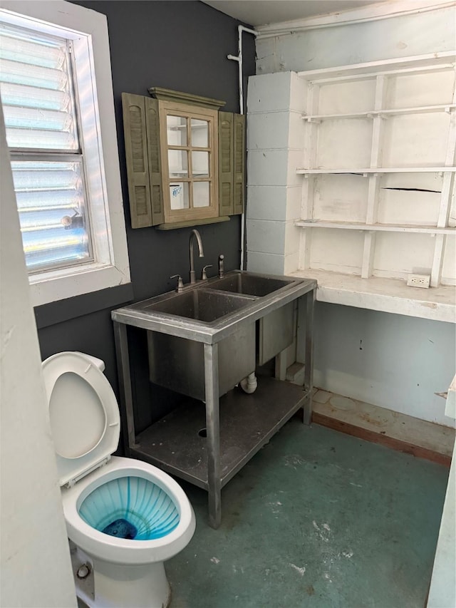 34 N Omega St, Galveston, TX 77568 - bathroom with concrete floors and toilet