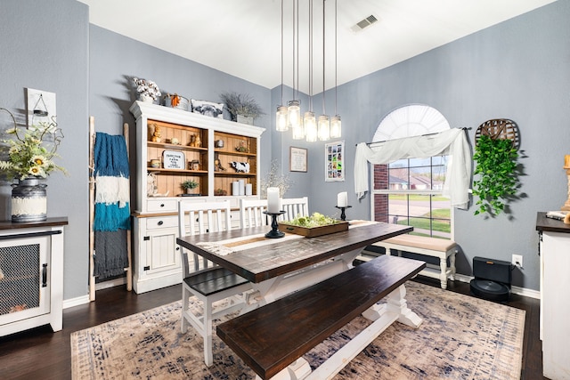 dining space featuring dark wood-type flooring, visible vents, baseboards, and heating unit