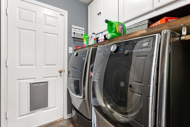 laundry area featuring independent washer and dryer and cabinet space