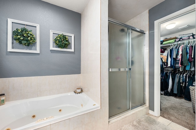full bath featuring a shower stall, tile patterned floors, a whirlpool tub, and a walk in closet