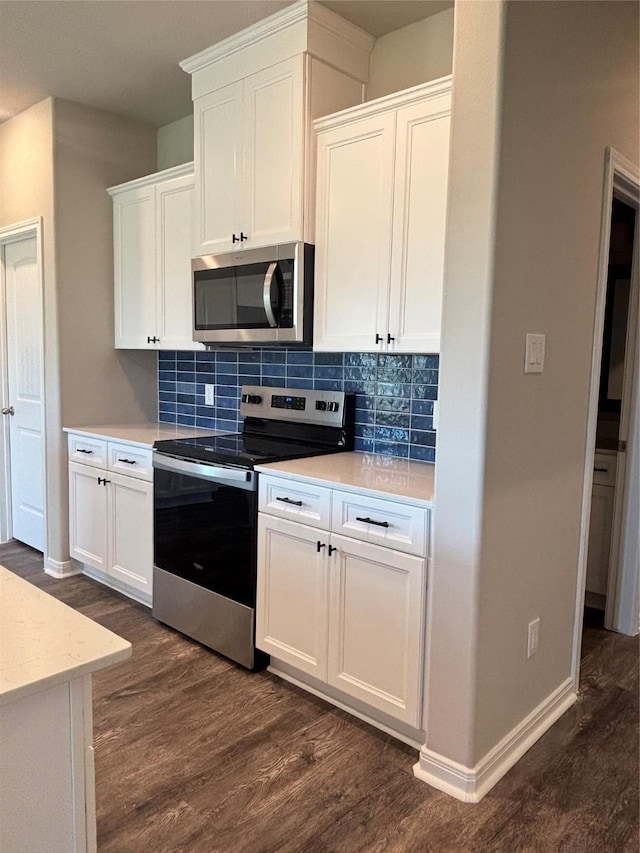 kitchen with stainless steel appliances, backsplash, dark wood-style floors, and light countertops