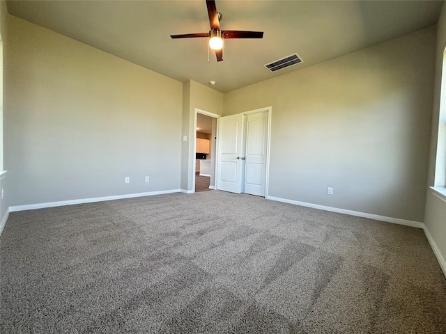interior space featuring visible vents, carpet flooring, baseboards, and ceiling fan