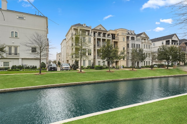 exterior space featuring a yard and a water view