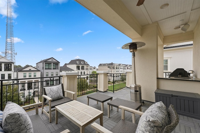 balcony featuring ceiling fan and a residential view
