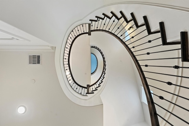 stairway with visible vents and ornamental molding