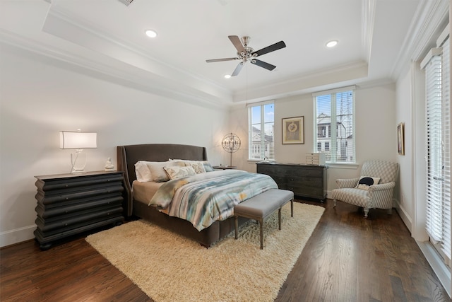 bedroom featuring dark wood-style flooring, recessed lighting, a raised ceiling, and crown molding