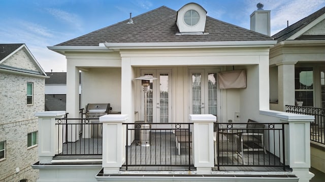 exterior space featuring stucco siding and roof with shingles