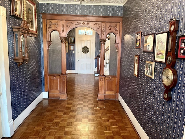 corridor with arched walkways, wallpapered walls, and baseboards