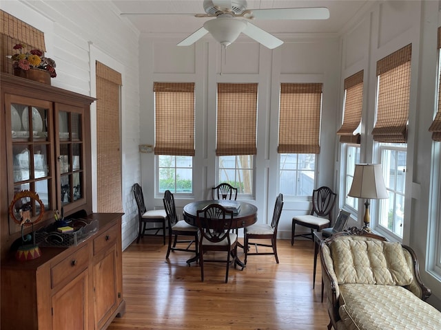 dining room with light wood-style flooring, ceiling fan, and ornamental molding