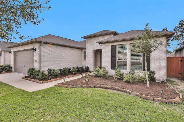 122 S Wild Petunia Trl, Montgomery, TX 77316 - view of front of home with a garage, brick siding, roof with shingles, and driveway