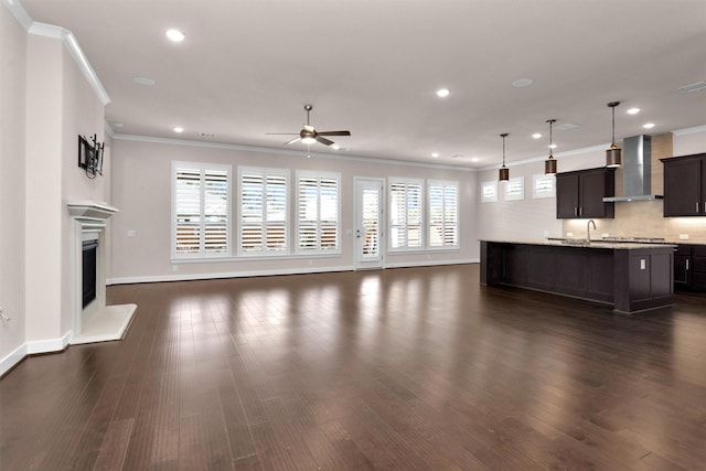 122 S Wild Petunia Trl, Montgomery, TX 77316 - unfurnished living room featuring ceiling fan, ornamental molding, plenty of natural light, recessed lighting, and baseboards