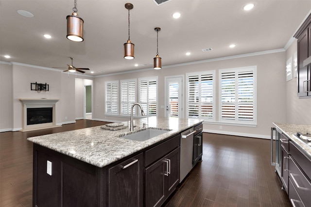 122 S Wild Petunia Trl, Montgomery, TX 77316 - kitchen featuring a sink, dishwasher, a ceiling fan, ornamental molding, and baseboards