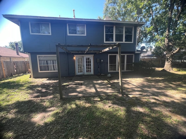 back of house with a pergola, a fenced backyard, french doors, a patio area, and a chimney