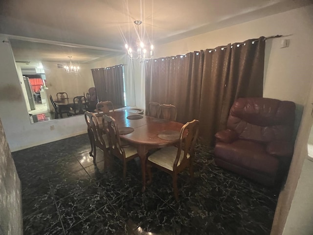 dining room featuring a chandelier and marble finish flooring