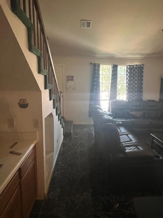 corridor with baseboards and stairway
