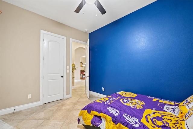 30614 Indigo Falls Dr, Brookshire, TX 77423 - bedroom featuring arched walkways, tile patterned flooring, ceiling fan, and baseboards
