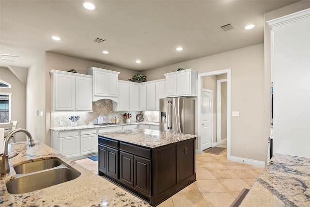 30614 Indigo Falls Dr, Brookshire, TX 77423 - kitchen featuring a sink, stainless steel refrigerator with ice dispenser, recessed lighting, decorative backsplash, and white cabinets