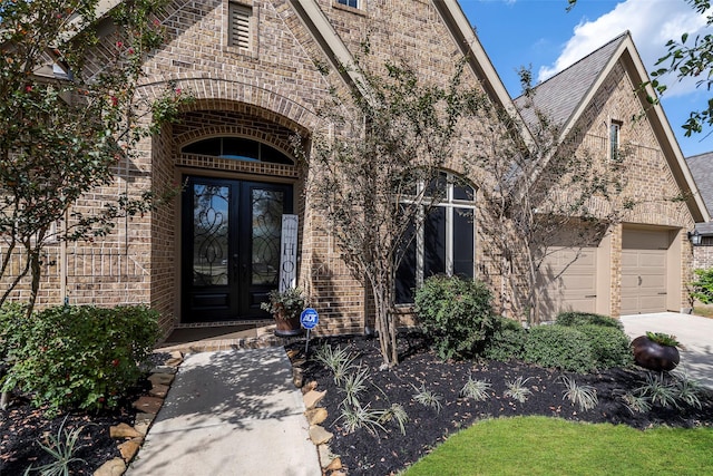 30614 Indigo Falls Dr, Brookshire, TX 77423 - doorway to property with concrete driveway, brick siding, french doors, and an attached garage
