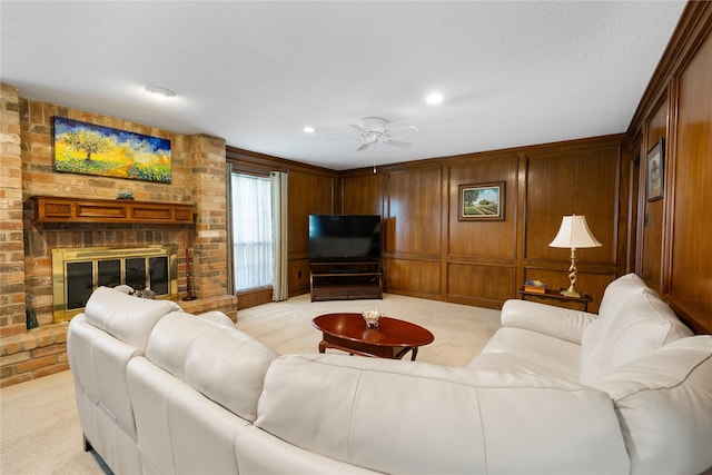 living area featuring a ceiling fan, recessed lighting, light carpet, and a fireplace